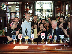 Les Maggs and Staff of the White Horse behind the bar recieving their certificate